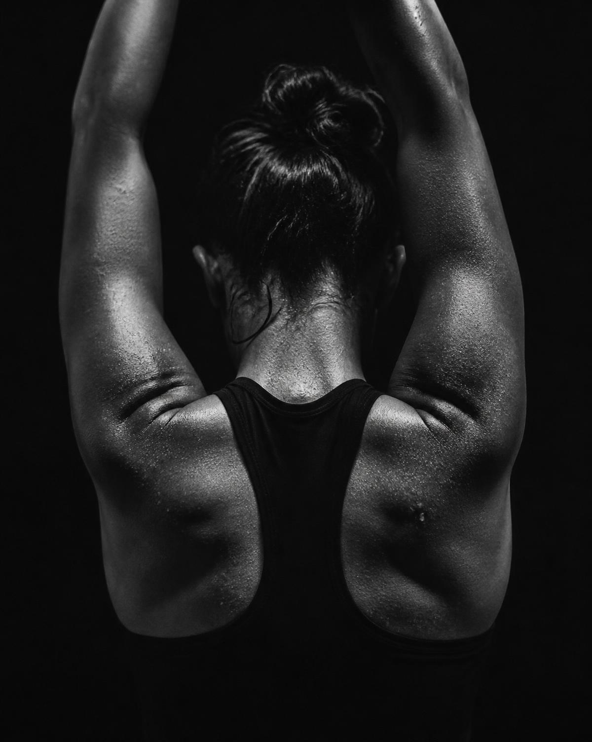 An athlete seen from behind with arms raised overhead